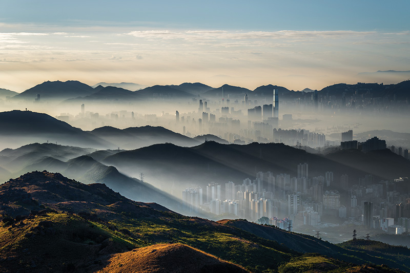 Hong Kong 
Best Place to Greet the Dawn
For those seeking a serene start to 2026, Tai Mo Shan – Hong Kong’s tallest peak at 957 metres – offers a soothing balm after fireworks and wild parties. Armed with a hot drink and a headlamp, make your way up the winding hillside, the chill of the night air sharpening your senses as the city sleeps far below. From the summit, watch the New Year quietly rise as the horizon spills gold over ridges and clouds, turning the familiar skyline into a heavenly realm. Skyscrapers emerge from the haze as if walking in the soft dawn, inviting a mindful beginning to the year. 
