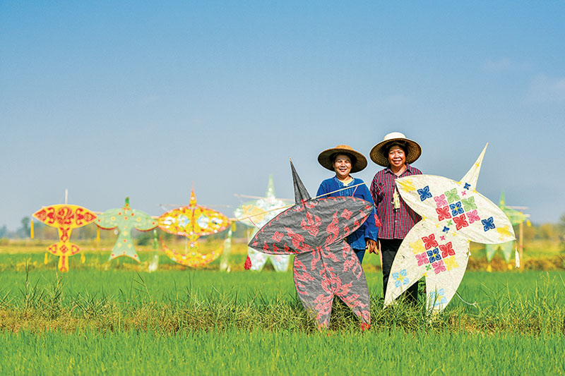 A couple of farmers show off their Chula kites